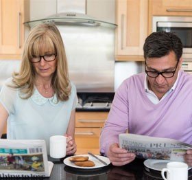 Reading the morning newspaper with UV Reader reading glasses
